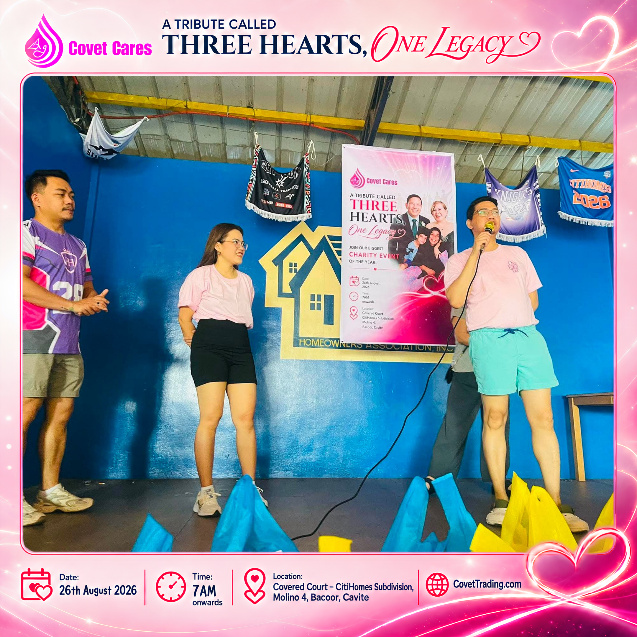 A speaker addresses attendees beside the THREE HEARTS, ONE LEGACY event poster.